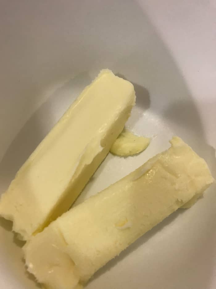 Start with a cup - 2 sticks - of real butter, at room temperature. Room temperature butter will whip more easily, and become fluffier. It's also easier to incorporate the powdered sugar without lumps. Real butter - not margarine - is a must.