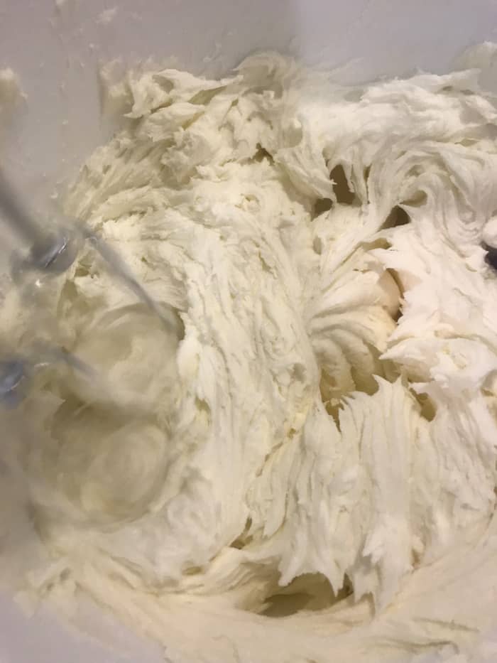 Beat, beat, beat...after adding the cream, you're almost done. Scraping down the sides of the bowl, beat the frosting until it reaches the desired consistency.