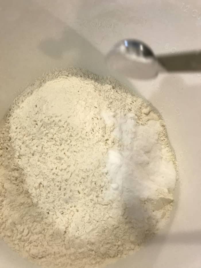 Whisk together flour, baking soda, baking powder and salt in a separate bowl. Set aside while creaming together the butter and sugar.