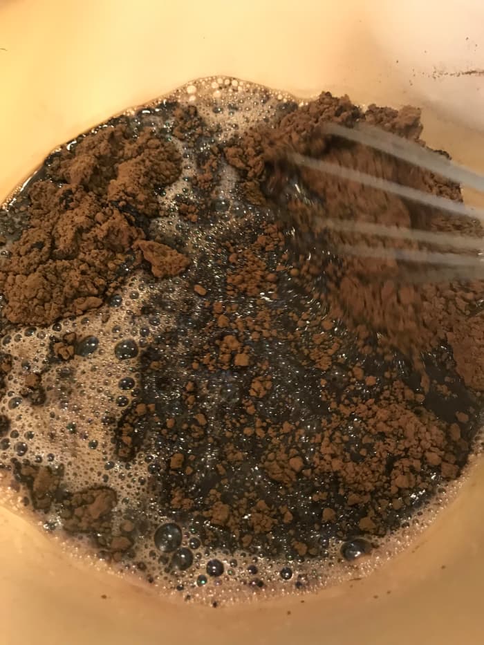 Whisk together the boiling water and cocoa powder until smooth. You'll have a very loose paste. Allow this mixture to cool as you prepare the other ingredients. Whisking occasionally helps it cool faster.