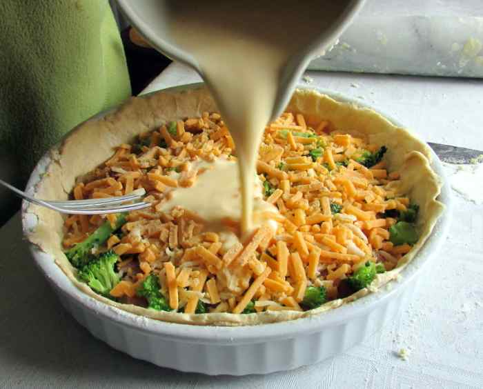Pour egg and milk over the quiche filling.