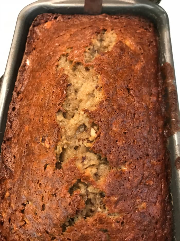 Bake for 60–70 minutes, or until risen, golden and a tester inserted into the middle comes out clean. Let rest in the loaf pan for about 10 minutes, then turn out onto a wire rack to cool completely.