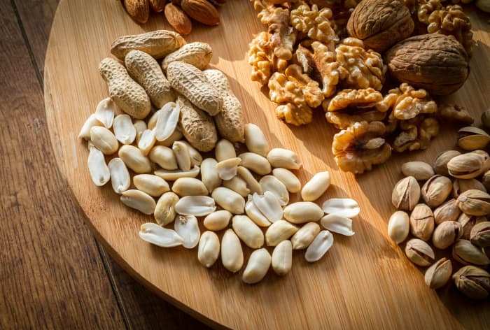 Unsalted whole nuts in the shell are a nutritious afternoon snack. And because they require a bit of extra work to get at, you're less likely to mindlessly shovel handfuls of them into your mouth.