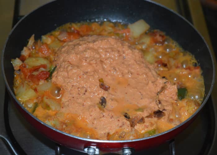 Step five: Add ground masala mix. Stir the mix till it becomes dry. You will now get a nice aroma from the roasted spices and cashew nuts.