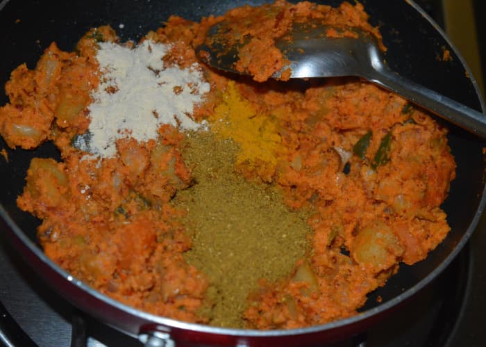 Step six: Add garam masala powder, turmeric powder, remaining salt, sugar, and dry mango powder. Saute for a minute.