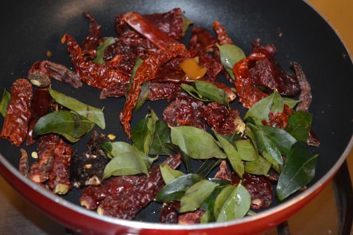 Step 4: Saute broken red chili, curry leaves, and hing/asafoetida in very little oil till they become crispy.