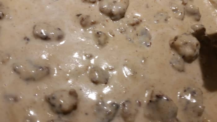 Add milk gradually, constantly stirring. Add more to desired gravy thickness. Simmer.