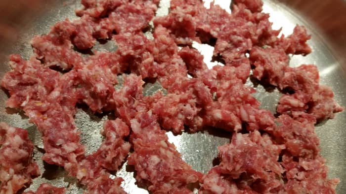 Tear or pull apart sausage and begin cooking in skillet. Be sure center of sausage has lost its pink color and is fully cooked.