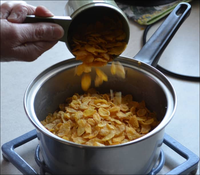 Cornflakes being added to frothing ingredients to make the Honey Joy biscuits.