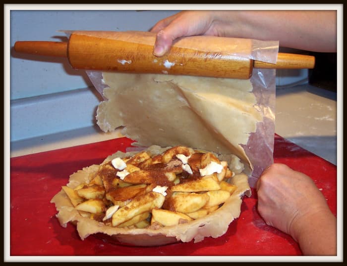 You may gently roll the dough onto the rolling pin, place one edge, crust side down and paper side up, on the edge of the pie plate and then unroll it. Or, gently lift the wax paper off the counter and place it on the pie plate.