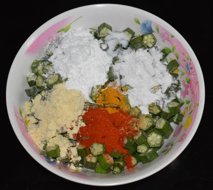 Step 2: Add corn flour, gram flour, rice flour, turmeric powder, red chili powder, chopped green chilies (optional), coriander powder, and salt.