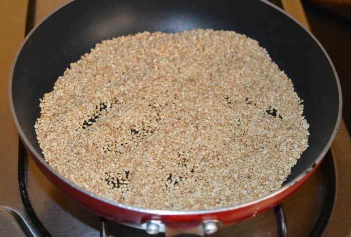 Step one: Put them in a deep-bottomed pan. Turn on the stove. Keep the heat low. Dry fry them till light golden brown while turning them often. Next, turn off the heat. Set aside for cooling.