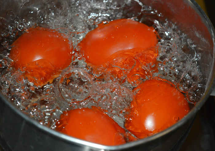 Step one: Boil the whole tomatoes in water for 1 minute. Turn off the heat. Cover the vessel with a lid.