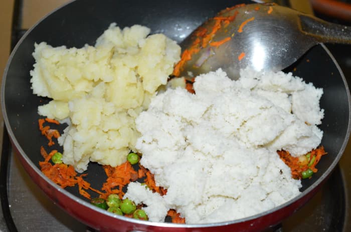 Step three: Now, add broken idlis and mashed potatoes. Combine well, so that there are no lumps in the dough.