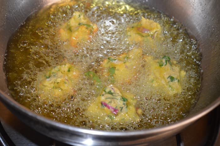 Step four: Take small portions of this batter and drop them in hot oil for frying. Don't overcrowd them.