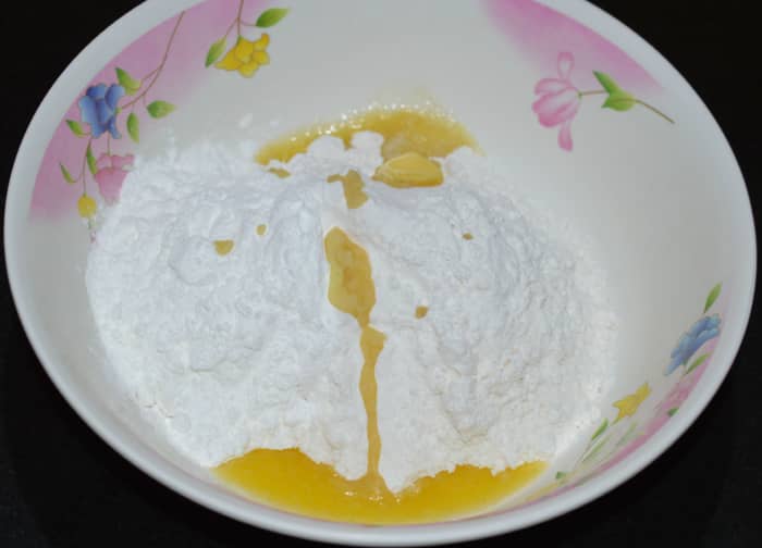 Step one: Make the dough for the wonton wrappers: Add all-purpose flour, corn flour, melted butter, and salt in a mixing bowl. Dry-mix.