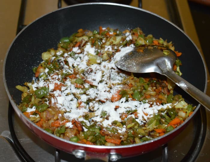 Step five: Sprinkle a few drops of water to make it moist. Add some plain flour as per instructions. Combine well. Turn off the heat. Now, stuffing is ready.