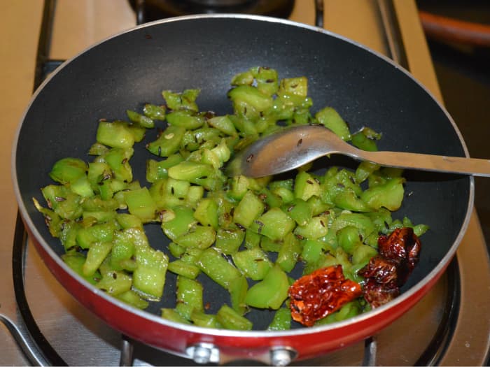 Continue sauteing over medium-high heat till capsicum gets cooked and becomes soft. You can add a few drops of water to keep it moist. Turn off the heat. Keep aside the mixture for cooling.