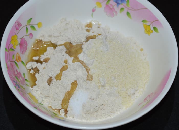 Step two: Take wheat flour, semolina, ghee, oil, and salt in another bowl. Knead, adding jaggery water little by little to get a firm and pliable dough.