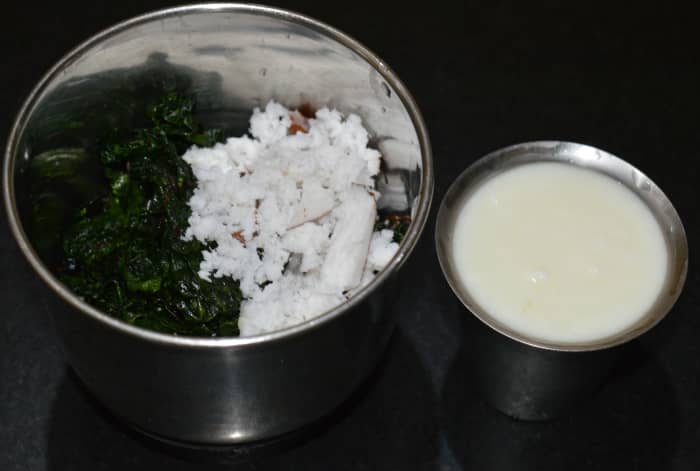 Step four: Put them to a mixer or blender when they cool down. Add grated coconut, salt, and curds. Grind to get a smooth paste.