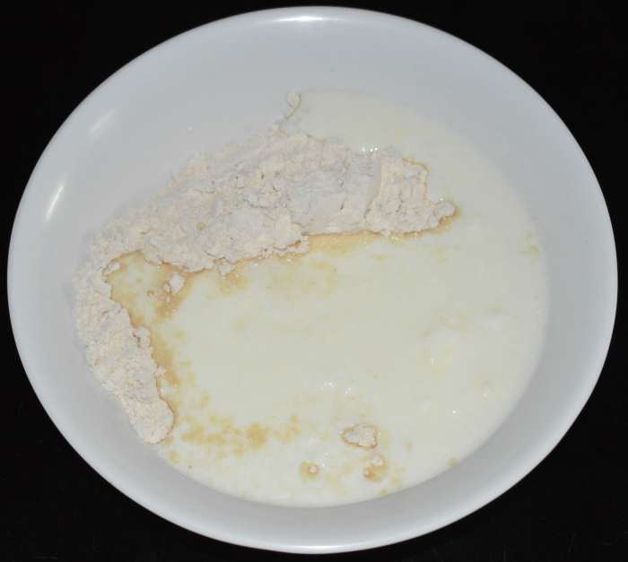 Step two: Mix wheat flour and yogurt or curds in a large mixing bowl. Add water to adjust the consistency.