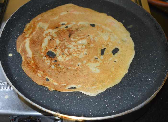 Keep the heat on medium-high. Flip it once the bottom becomes golden brown. Add a few drops of oil on the other side, also.