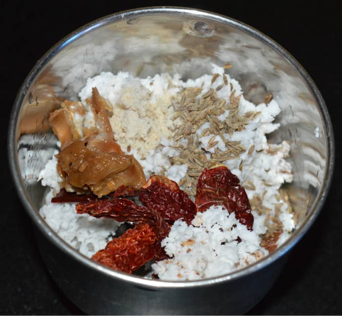 Step two: Grind grated coconut, dry red chilies, tamarind, and cumin seeds with water to get a smooth paste.