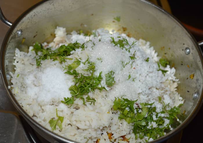 Step seven: Add beaten rice, grated coconut, sugar, salt, lemon juice, and chopped coriander leaves. Keep the heat minimum.