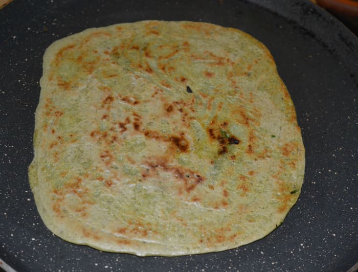 Step six: Let the bottom become golden brown. Flip it. Cook till the other side is also golden brown. Next, remove the pancake and place it on a serving plate.
