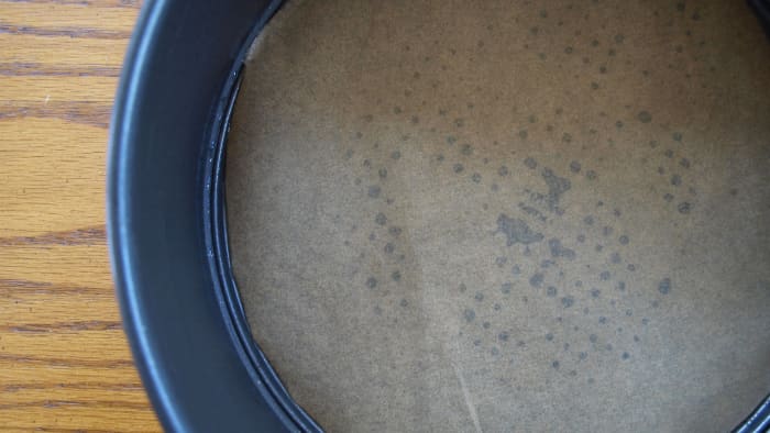 This is a springform pan lined with parchment paper.