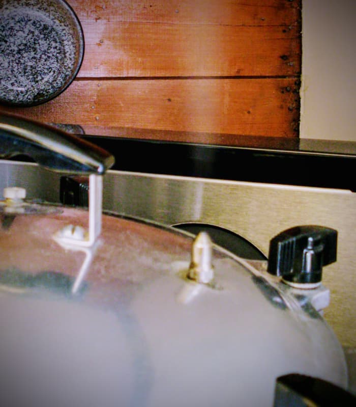 Now the steam is coming through the pressure spout. Wait 10 minutes (older sources may say seven) to put the weight on, at 10 lbs. pressure. Venting the pressure canner for 10 minutes ensures that the air is forced out of the canner.
