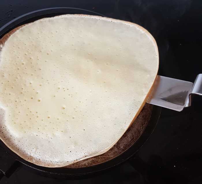 Taking a quick peek. You can see the holes mentioned on top of the pancake. This one is ready to flip.