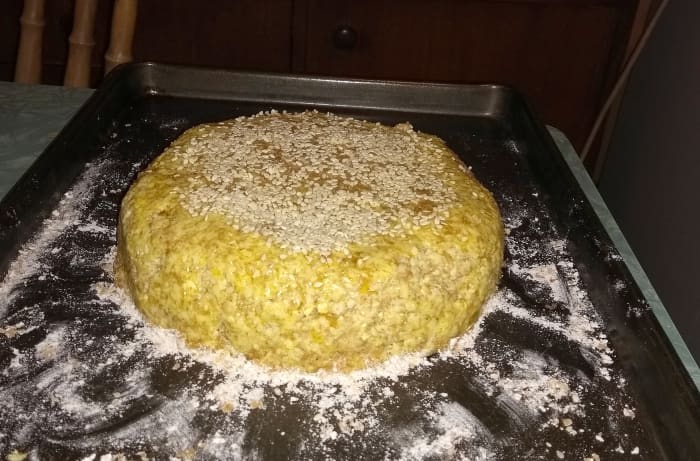 Spoon out onto a floured baking tray and shape with a dessert spoon and wooden spoon. Alternatively, knead into a flattened ball on a work surface before transferring to the tray.