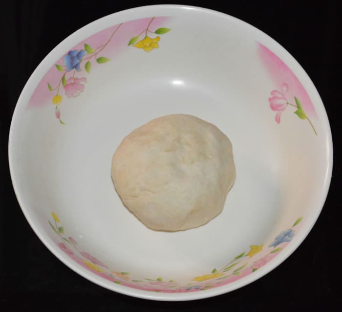 Knead, adding water to get a firm and smooth dough. Cover the dough and rest for at least 30 minutes.