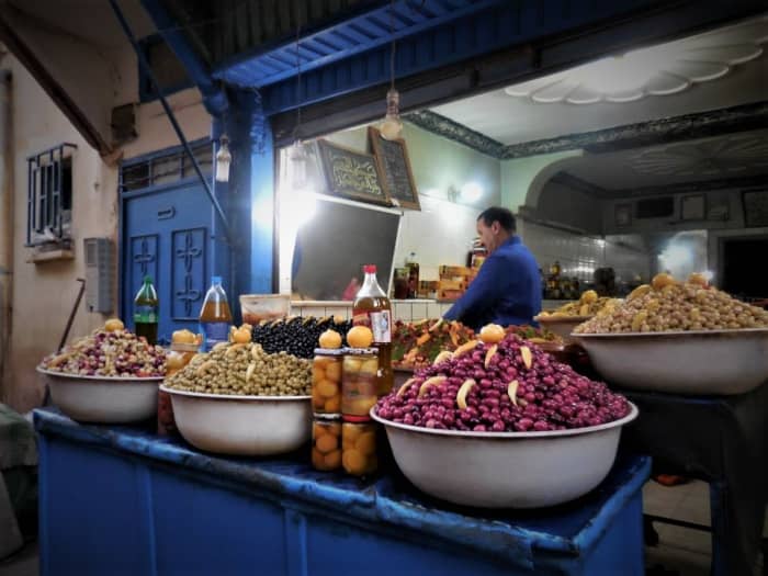 In Azrou, a small town south of Fez, a shopkeeper shows an impressive display of olives. Preserved lemons in jars are placed around the olive basins.