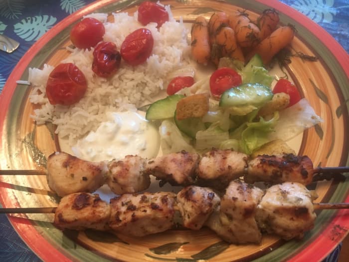 Chicken Souvlaki served with Basmati Rice with Grilled Cherry Tomatoes, Carrots with Dill, Greek Salad and a side of Tzatziki Sauce