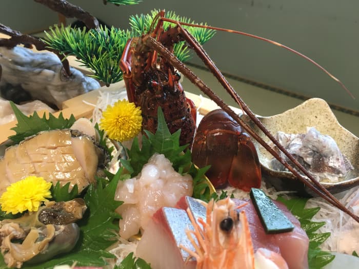 Ise ebi looks like lobster (this is a sashimi plate that included raw ise ebi, right in front of the decorative shell)