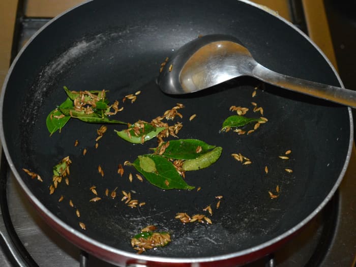 Step 2: Heat butter/ghee/olive oil in a deep-bottomed pan. Throw in the cumin seeds. Let them splutter. Add the curry leaves. Saute for a few seconds.