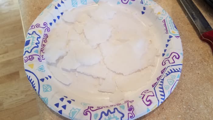 Remove your coconut oil from the freezer. It only needs a few minutes. Chip it off of your plate into small chunks.