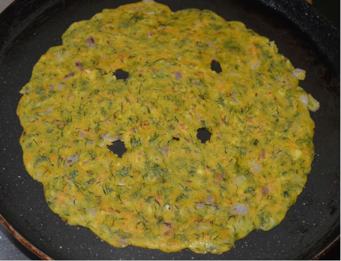 Once both sides of the roti become a bit golden brown, remove it from the pan and place it on a serving plate.