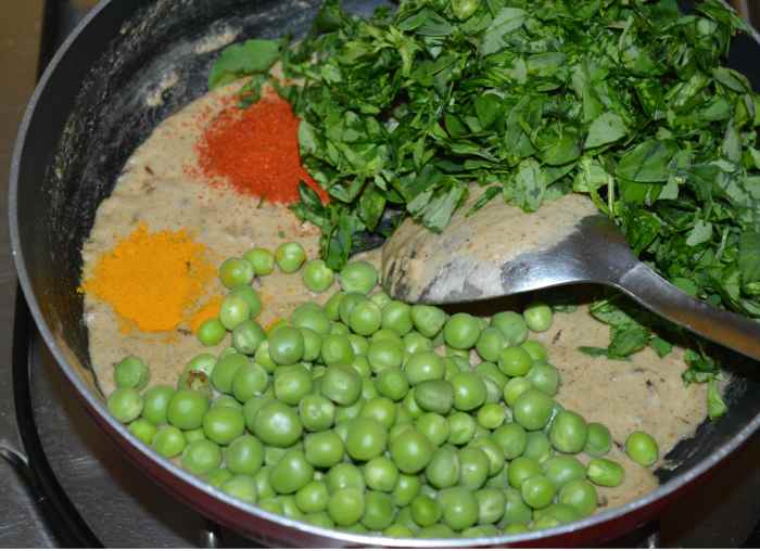 Step five: Add the green peas, chopped fenugreek leaves, turmeric powder, red chili powder, salt, and sugar. Mix thoroughly.