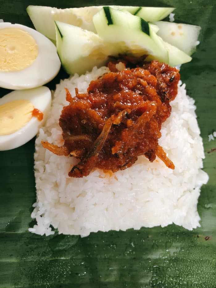 One of my favorites Malaysian signature dishes called nasi lemak. As you can see here, sambal ikan bilis is served on top of fragrant coconut rice with fresh sliced cucumber and hard boiled eggs.