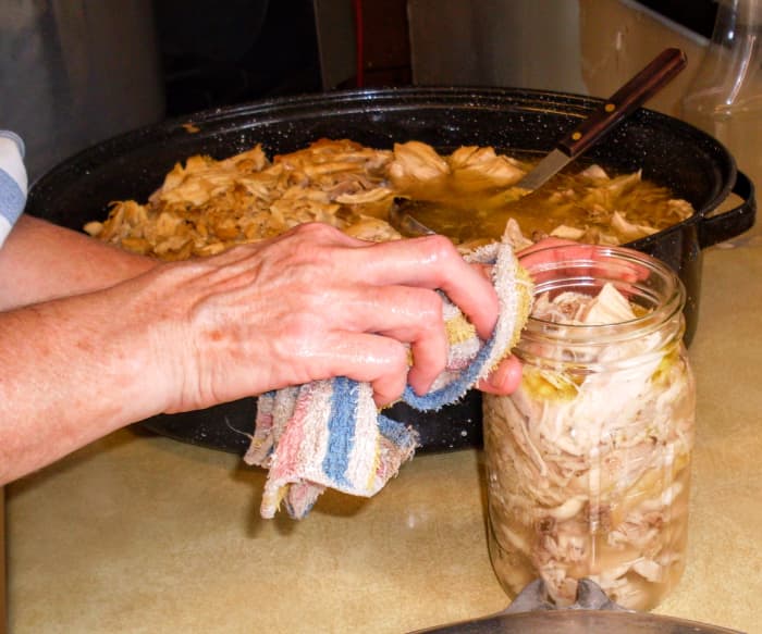 Set aside each jar, dribbles and all, and proceed to fill as many as your canner will hold (usually seven quarts).
