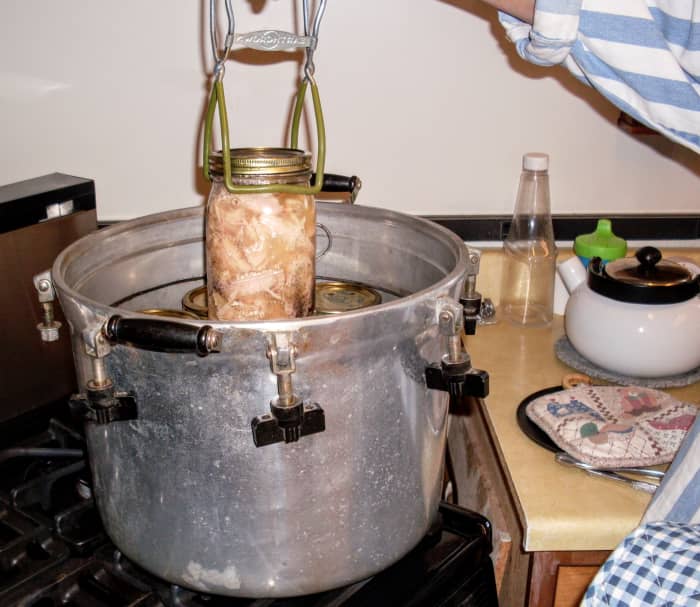 Lift each jar out carefully with a jar lifter. If you have waited for the canner to cool sufficiently, you should be able to remove the jars promptly.