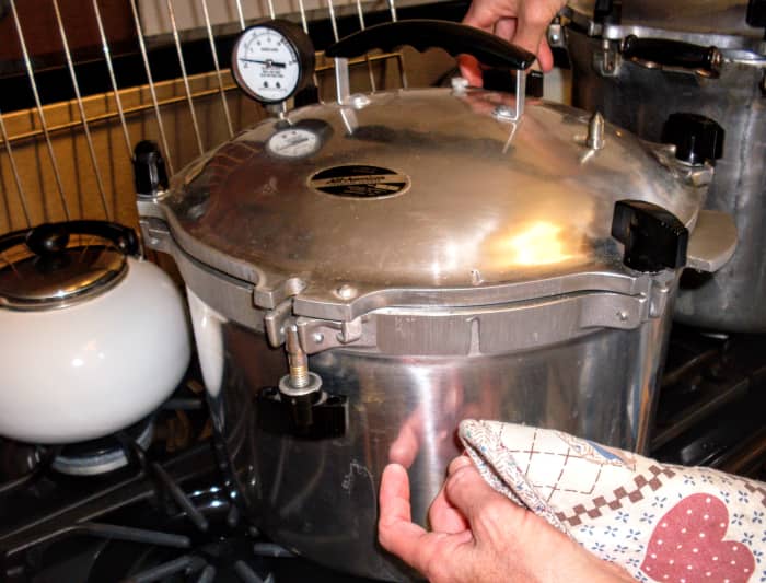 Once all screws are tightened, heat on low to medium heat until the steam vent is hissing and spitting, then wait 7-10 minutes to place the weight on for 10 lbs. pressure. Waiting ensures the canner is properly pressurized.