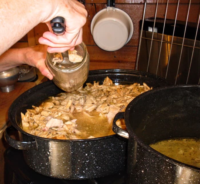Use a slotted spoon or your hands to pack meat firmly into jars, to within 1" of the top. (Where the neck of the jar ends is usually about right.)
