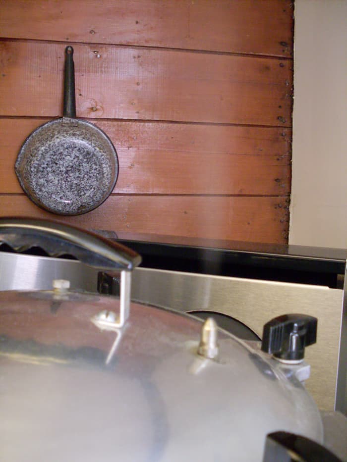 Now the steam is coming through the pressure spout. Wait 10 minutes (older sources may say seven) to put the weight on, at 10 lbs. pressure. Venting the pressure canner for 10 minutes ensures that the air is forced out of the canner.