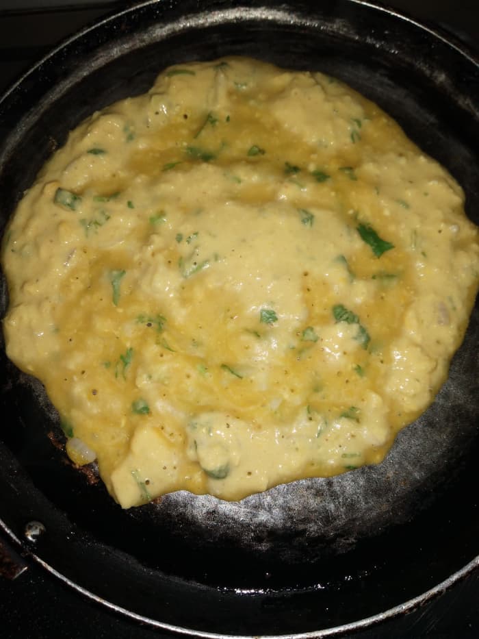 Heat tawa, and grease with oil. Pour ladle full of batter in the center and rotate the batter with the help of a ladle in a circular motion to make a round dosa.