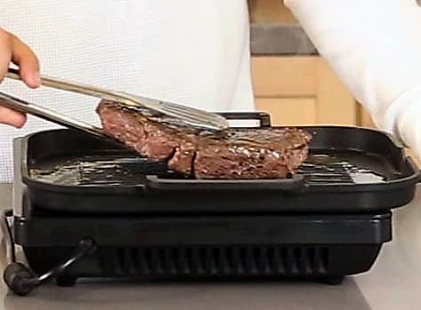 After it's cooked, take the food out of the bag and place it on a pan or grill to either sear it, grill it, or broil it.