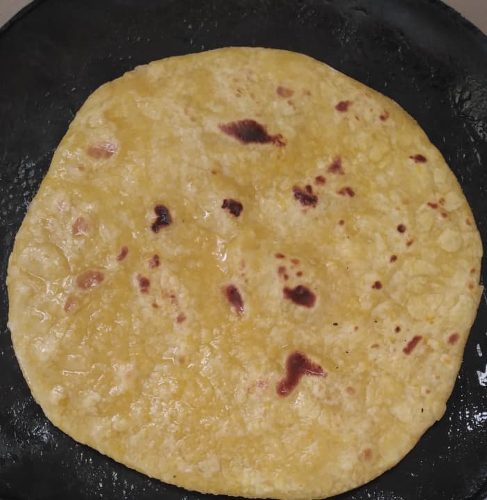 Apply 1 tablespoon of oil on the cooked side. After 1 minute, flip it and apply oil on the other side.